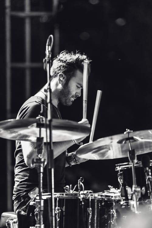 Free Grayscale Photo of a man playing drums Stock Photo