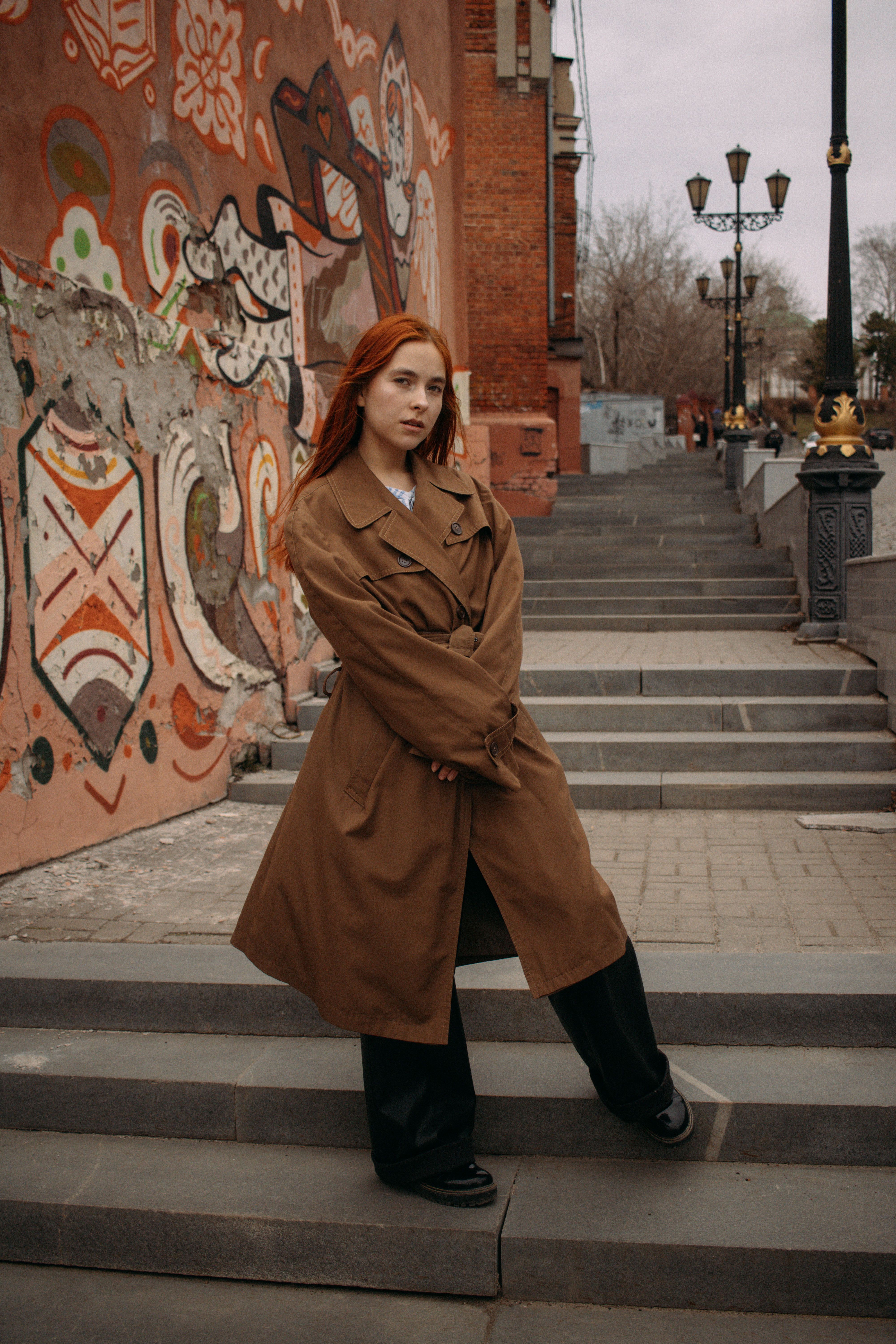Woman in Trench Coat Walking Down Alleyway · Free Stock Photo