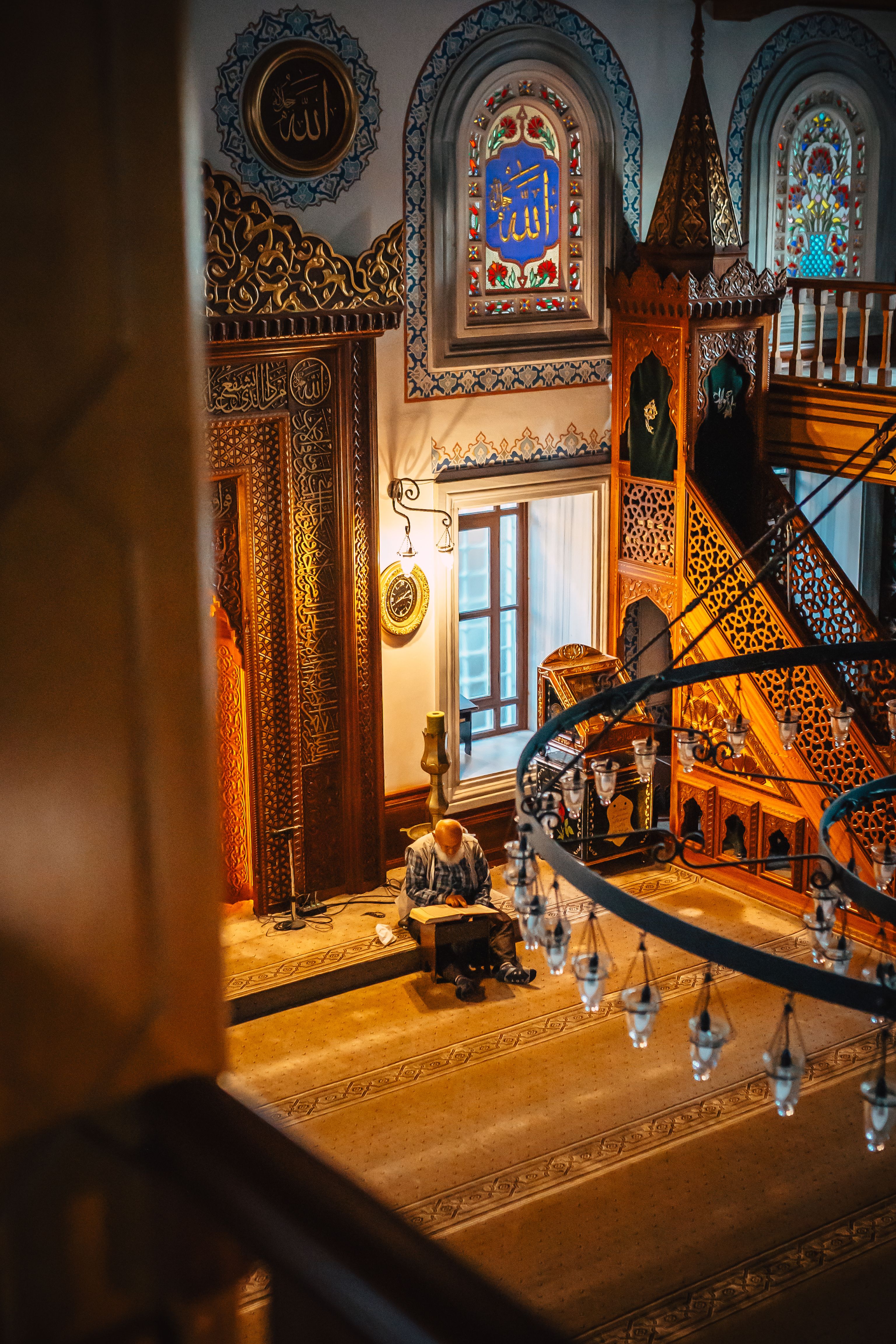 Man Sitting Inside Antique Mosque with Wooden Interior Reading Book ...
