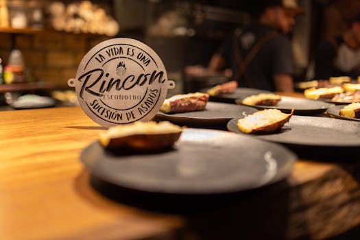 Close-up of artistic dishes with gourmet food in a warmly lit restaurant setting.