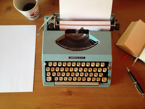 Teal Typewriter Beside Printer Paper