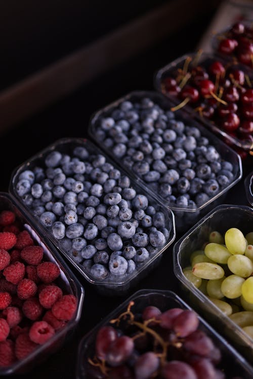 A close up of a bunch of berries and grapes