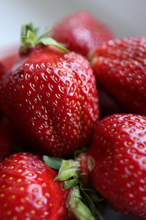 Free A close-up view showcasing the vibrant red texture of fresh strawberries. Stock Photo