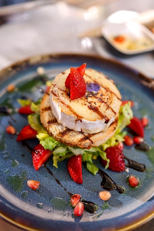 Free Indulgent dessert featuring cheese and strawberries on a gourmet plate. Stock Photo