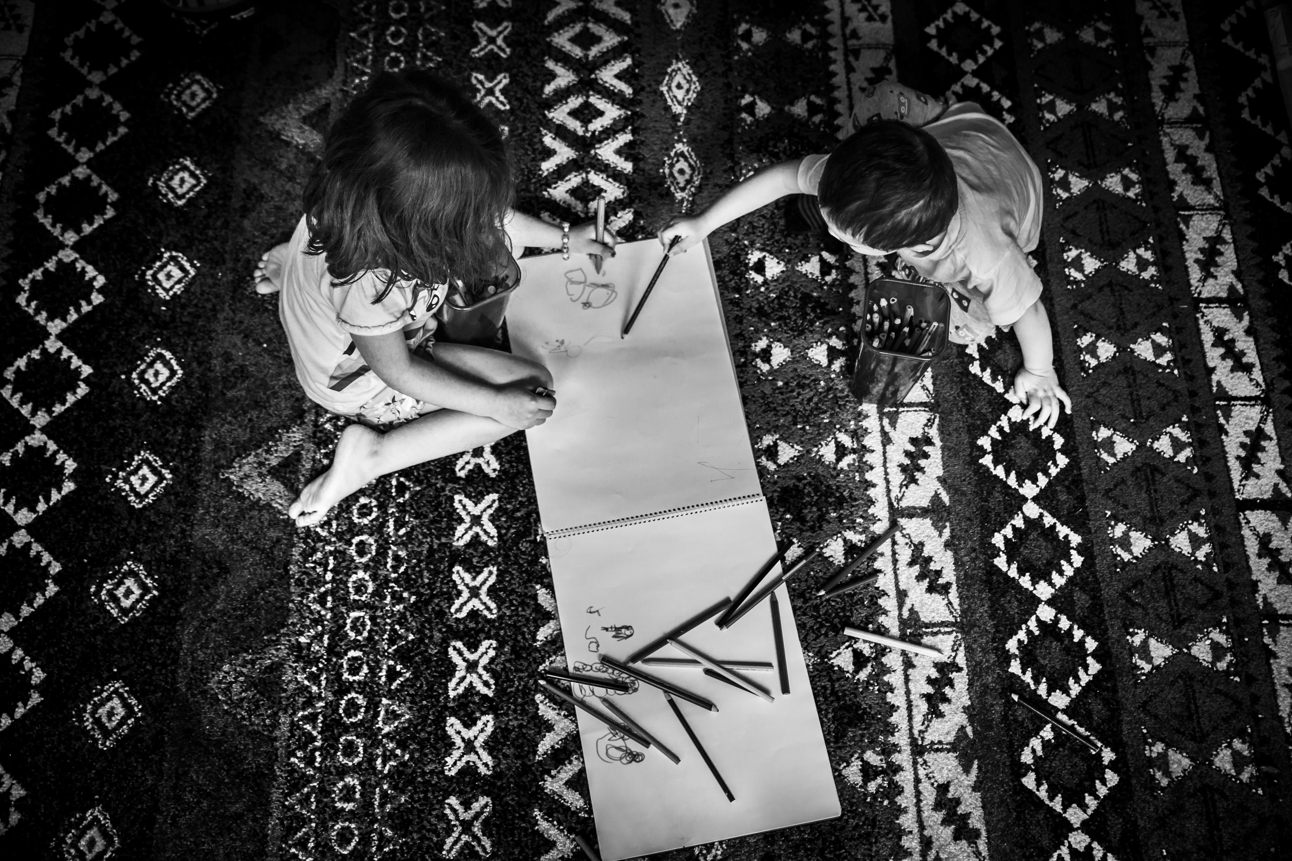 Two Toddlers Writing On A Sketch Pad Free Stock Photo