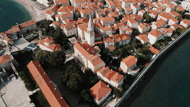 Discover picturesque Budva's historic charm with its red-roofed old town by the sea.