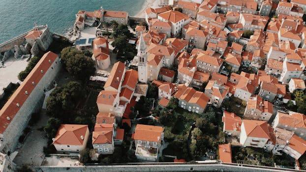 Stunning aerial view of Budva's Old Town with iconic red roofs and stone buildings.
