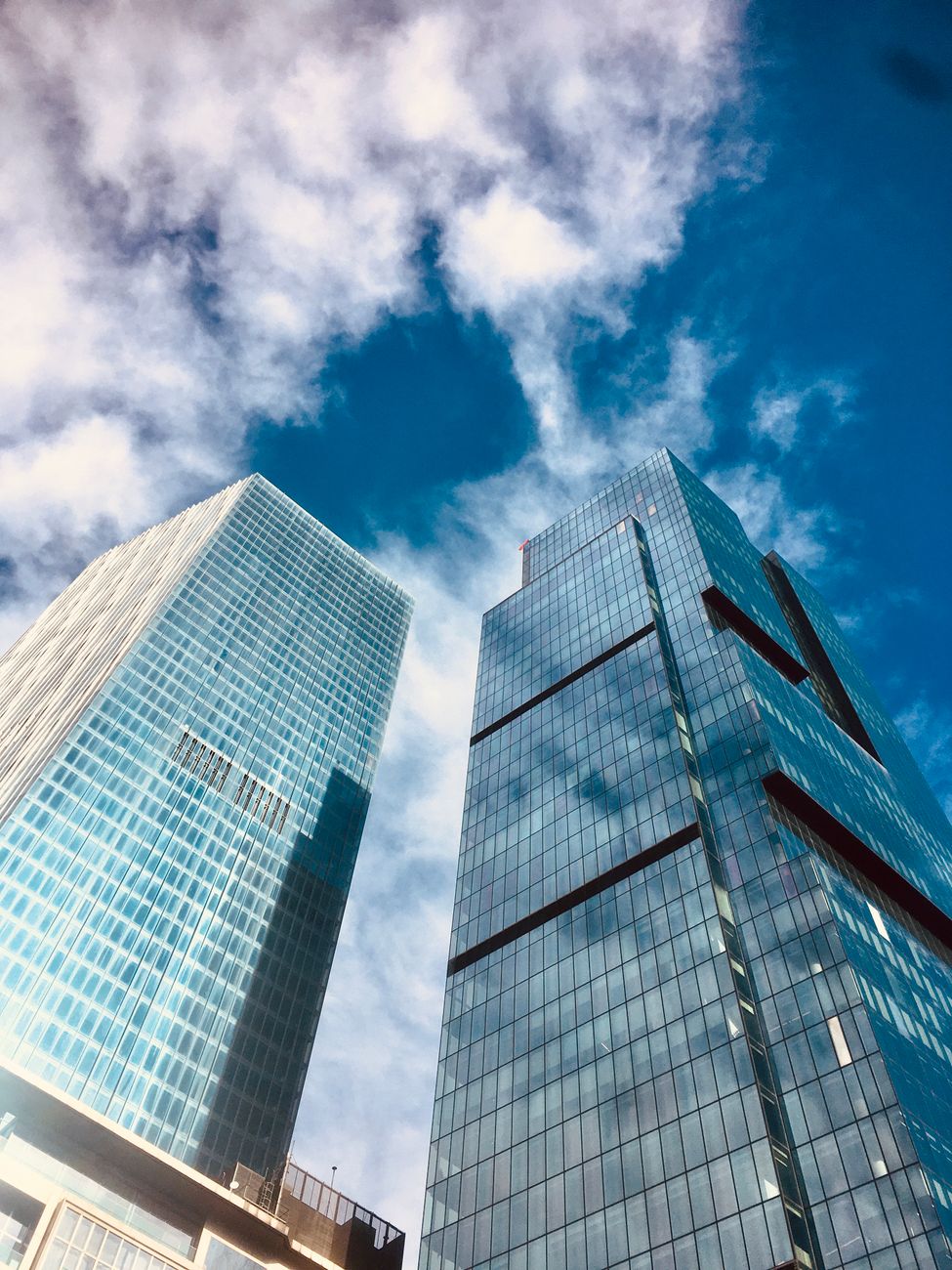 High-rise skyscrapers against a blue sky in Istanbul's financial district, showcasing modern architecture.