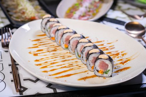 Free Close-up of sushi roll with soy sauce drizzle, showcasing fresh ingredients and Japanese culinary art. Stock Photo