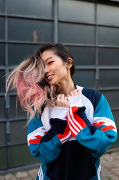 一位面带微笑、发色缤纷、身着时尚夹克的女性肖像，充满活力与时尚感