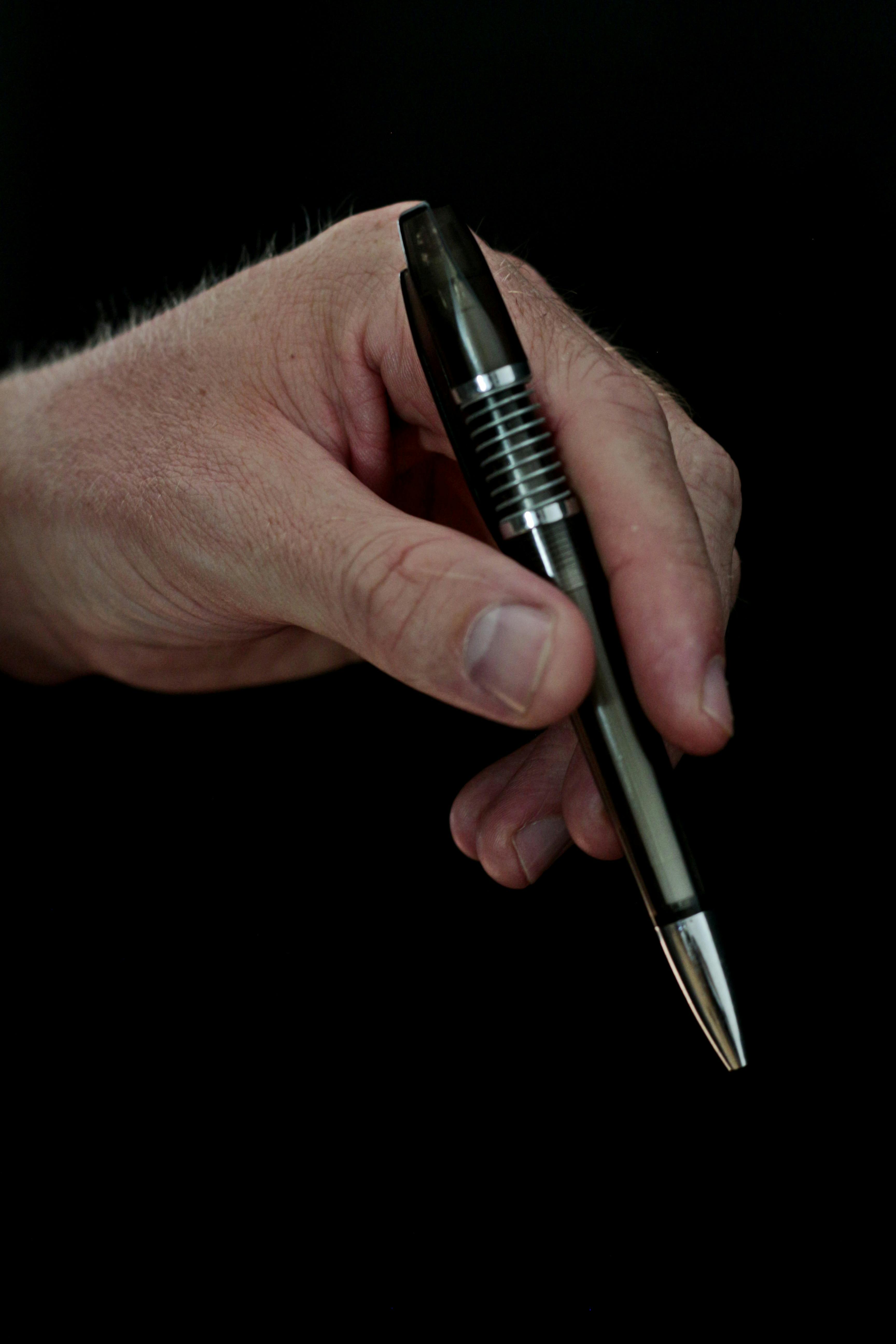 Person Holding Click Pen