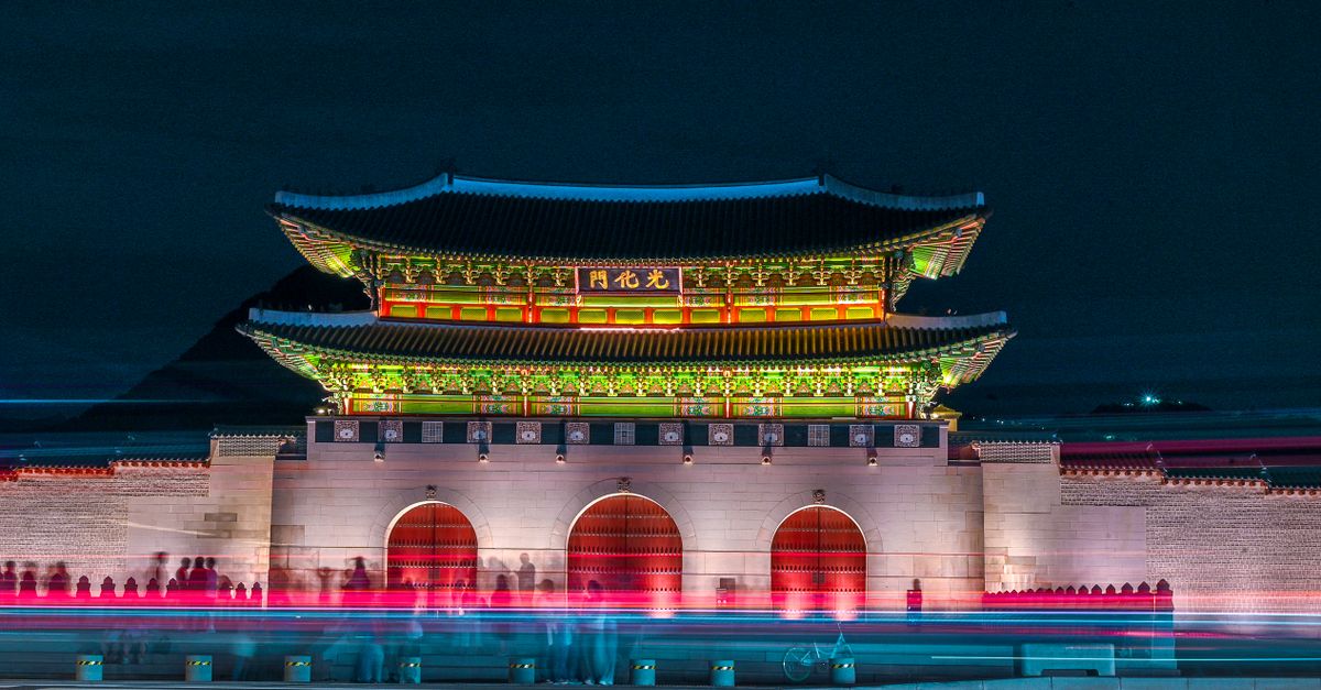 불빛이 켜진 한국 궁궐 전각이 밤하늘 아래 고즈넉하게 서 있는 야간 풍경