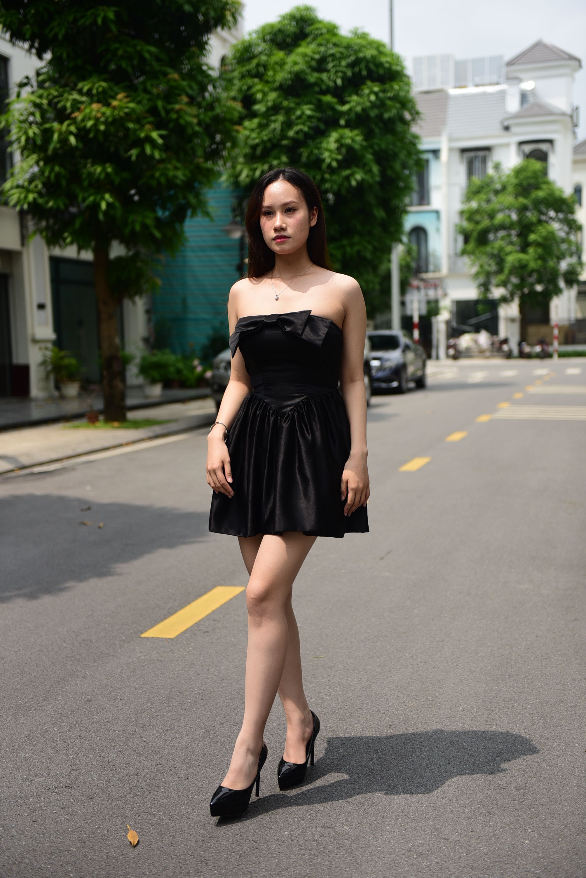 A Woman in a Black Dress Walking the Street · Free Stock Photo