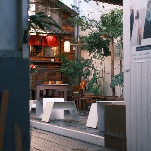 Free Charming rustic outdoor patio with wooden furniture in a cozy cafe setting. Stock Photo