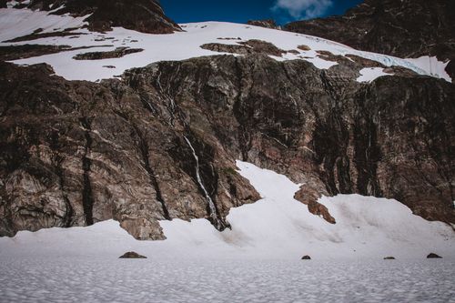Free A breathtaking view of snow-capped rugged mountains under a clear sky. Stock Photo