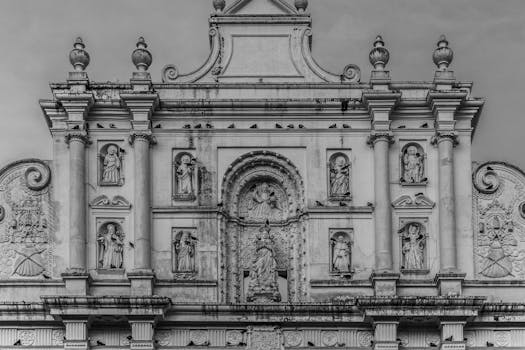 Intricate facade of a historic cathedral in Antigua, Guatemala, in black and white.