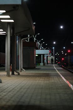 Moody night view of a quiet railway station platform in Chekhov, Russia.