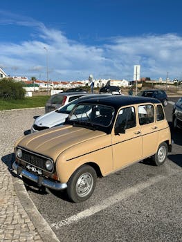 Retro beige car parked in Lisbon, Portugal, offering a nostalgic feel.