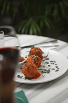 Tantalizing arancini served on a stylish plate in an upscale restaurant.
