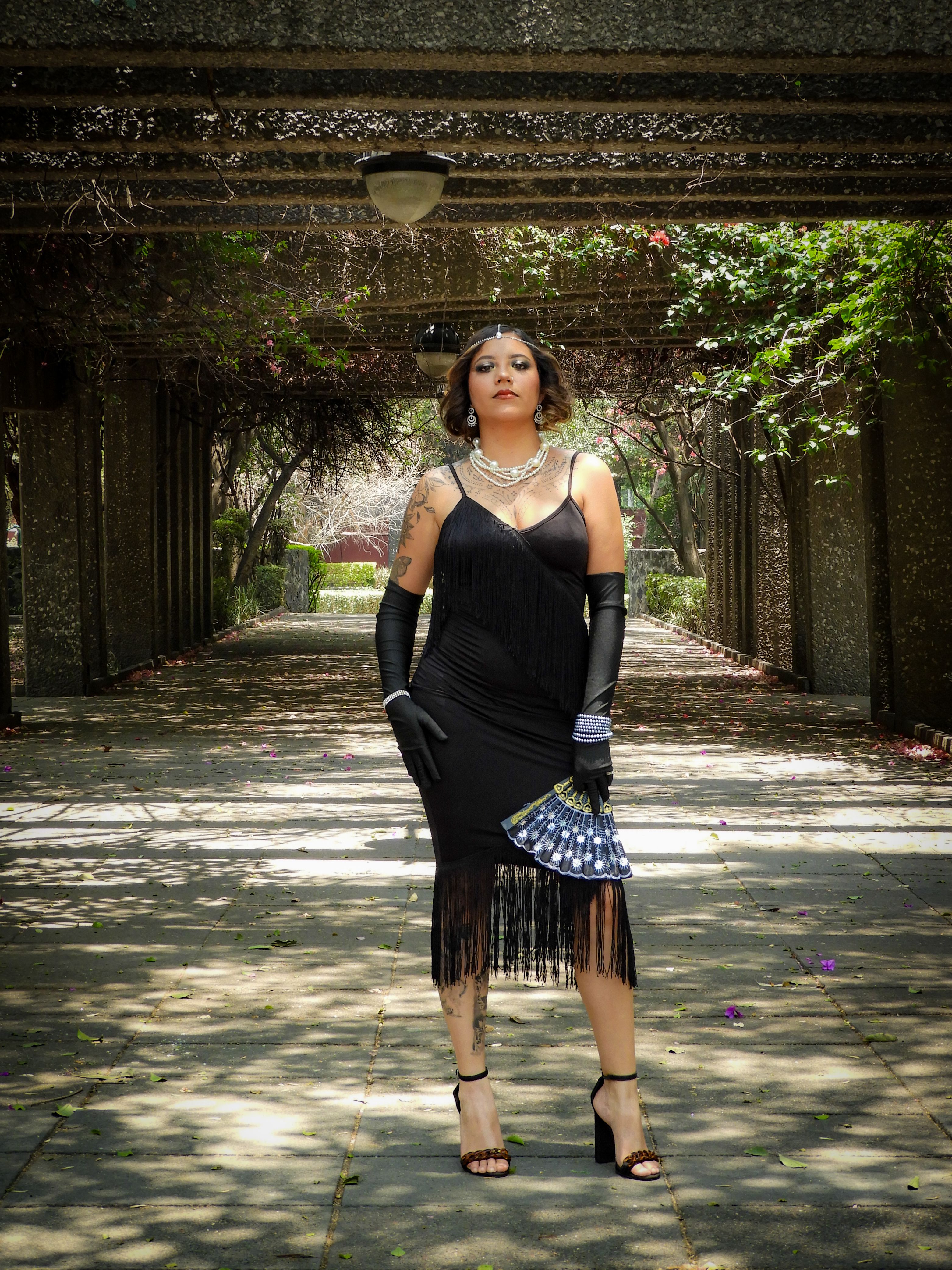 Woman Posing in a Black Dress in a Park · Free Stock Photo