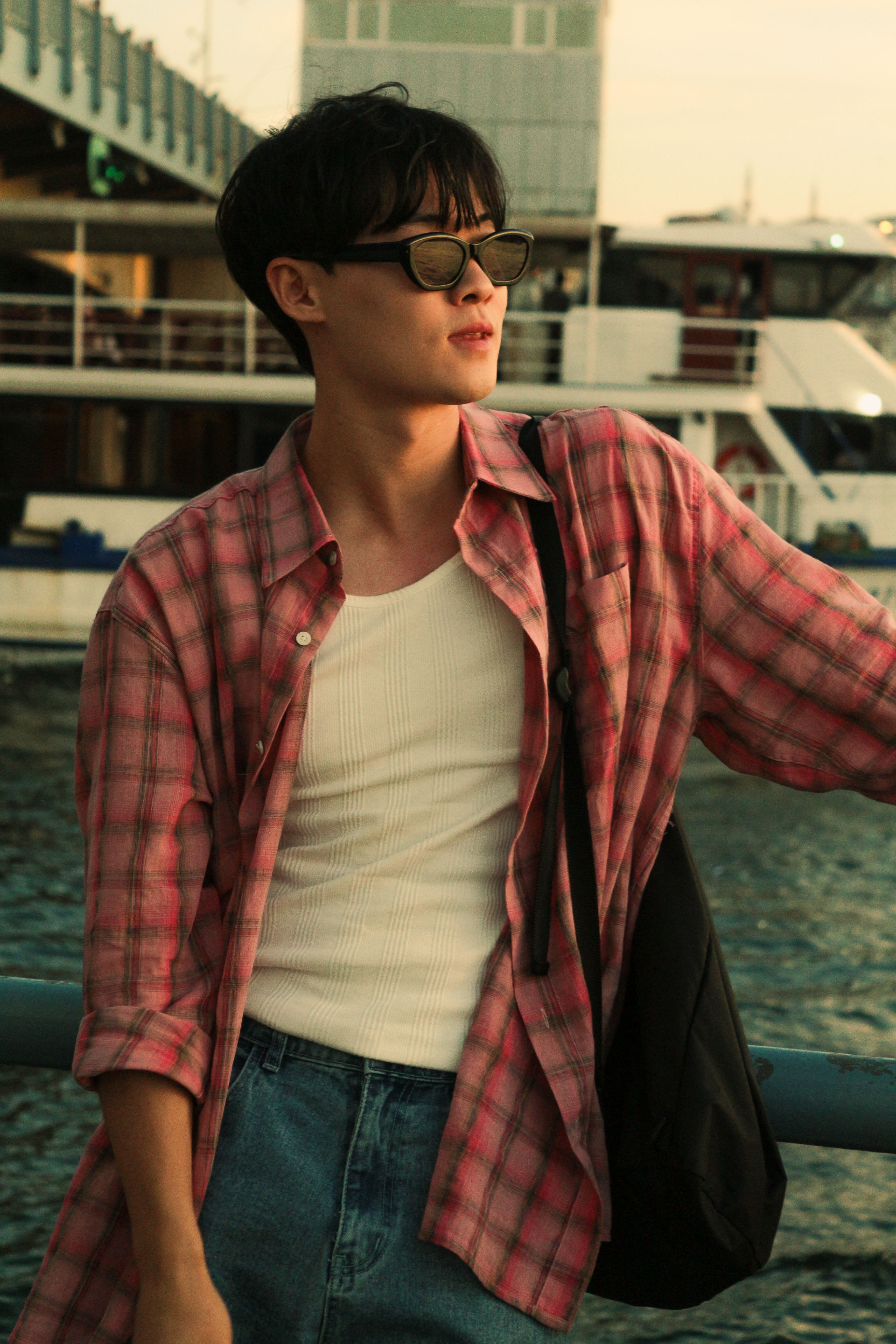 young man in a checkered shirt posing on a cruise ship