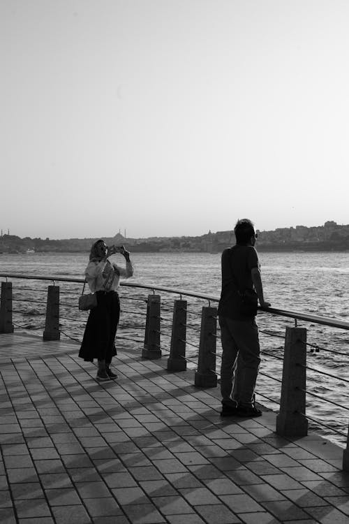 A couple taking a photo on the waterfront