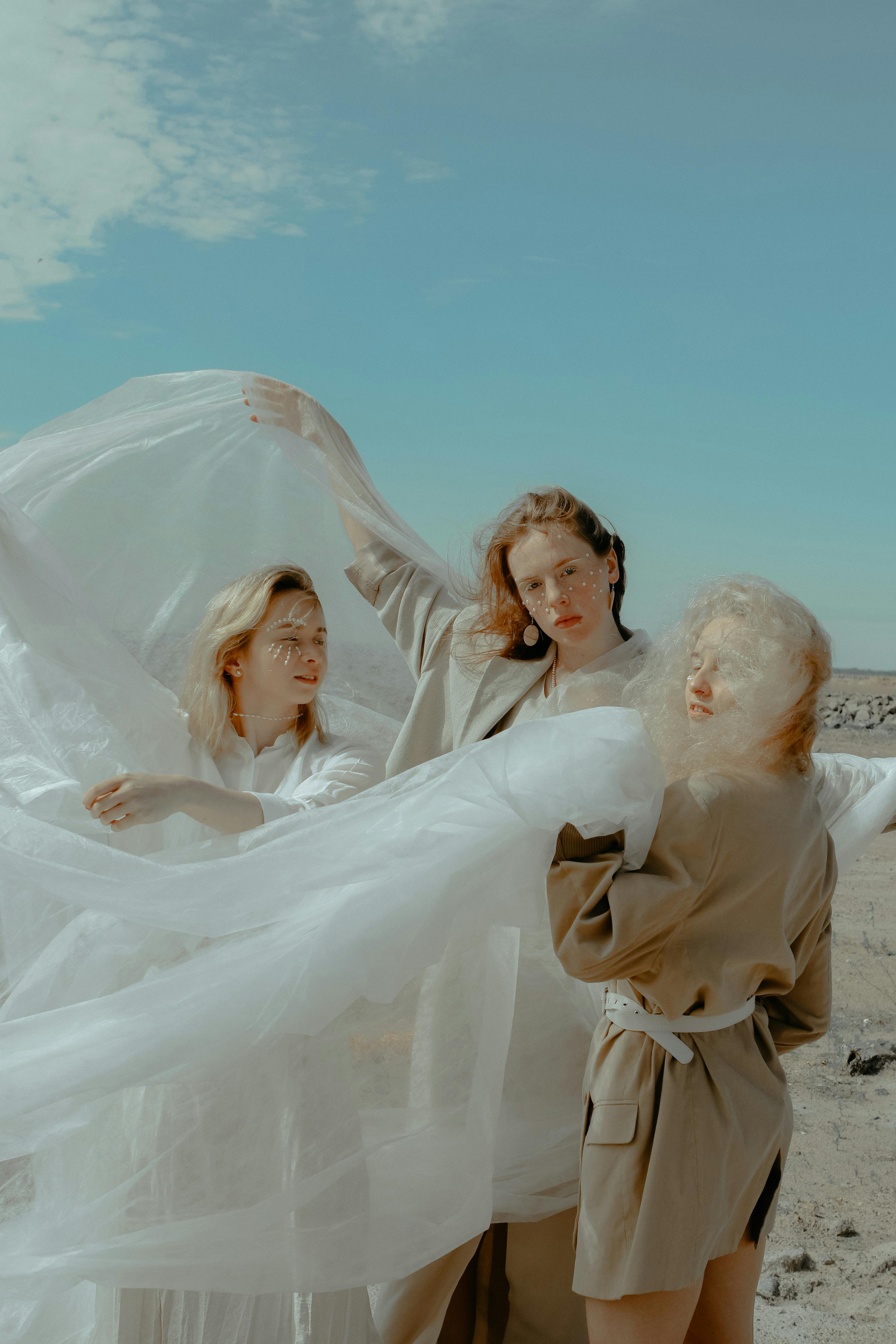 photo of women holding veil