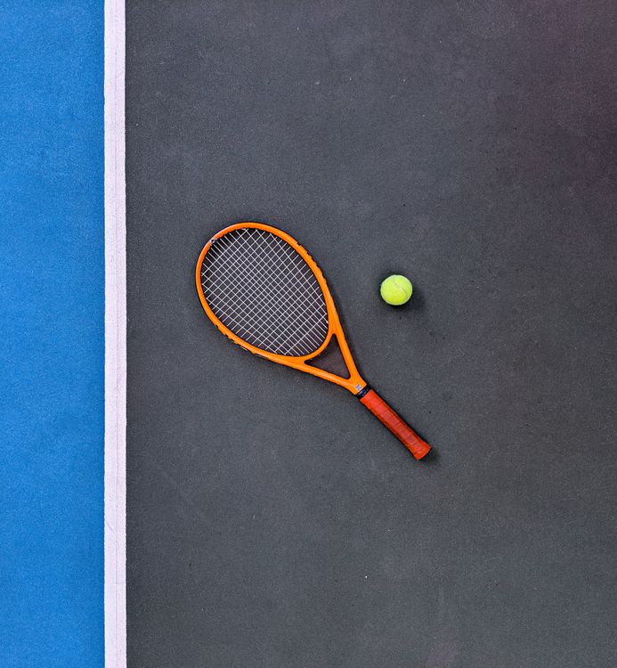 Orange Tennis Racket Beside Green Tennis Ball