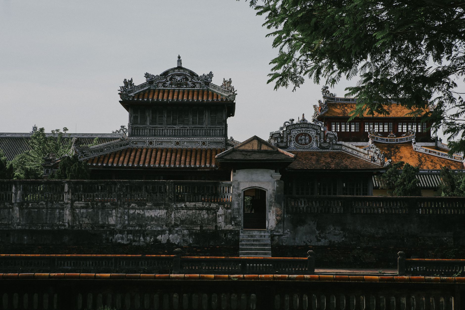 The majestic Meridian Gate of Hue, showcasing Vietnamese architectural elegance amidst lush greenery.