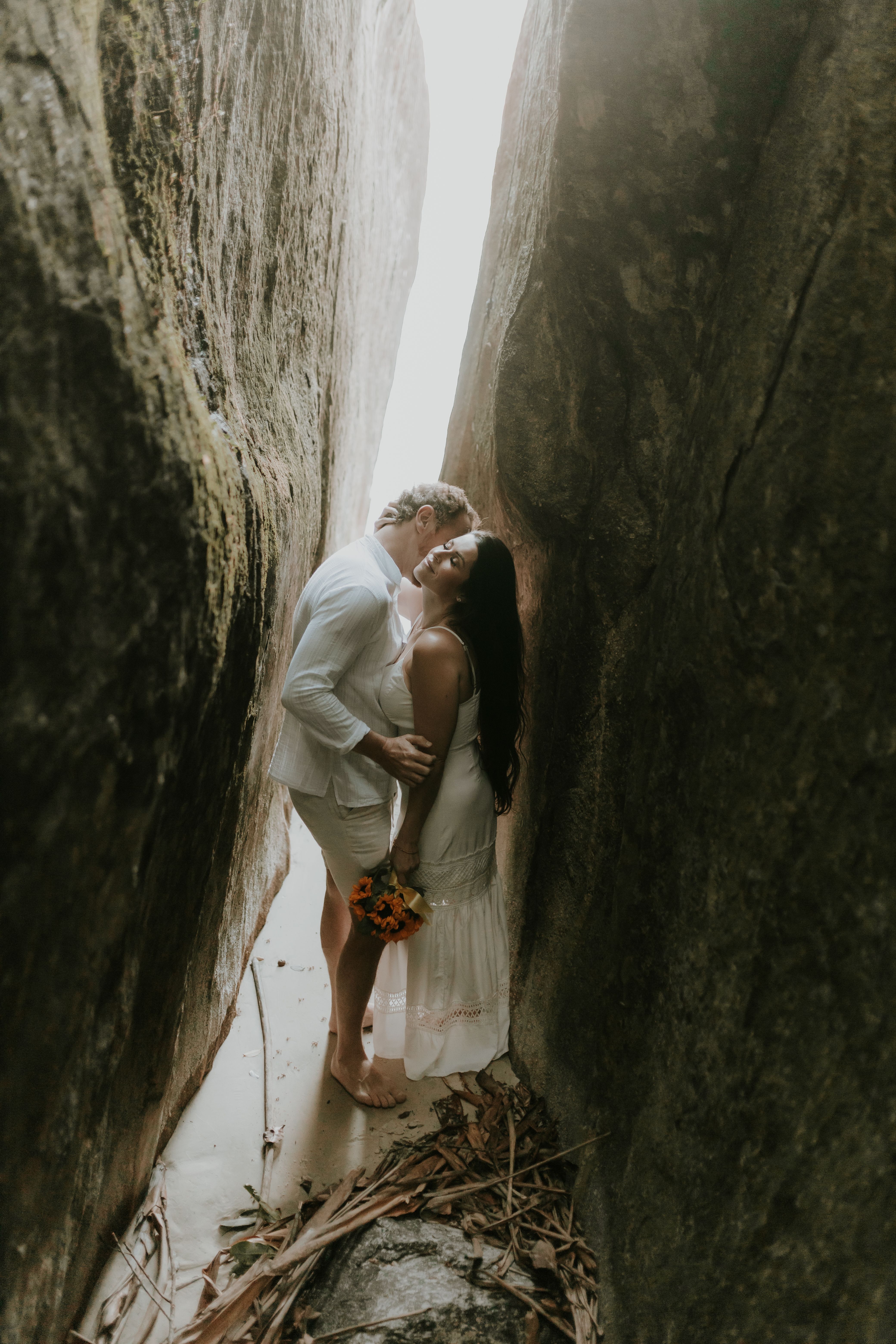 A Couple Standing Between Two Rocks · Free Stock Photo