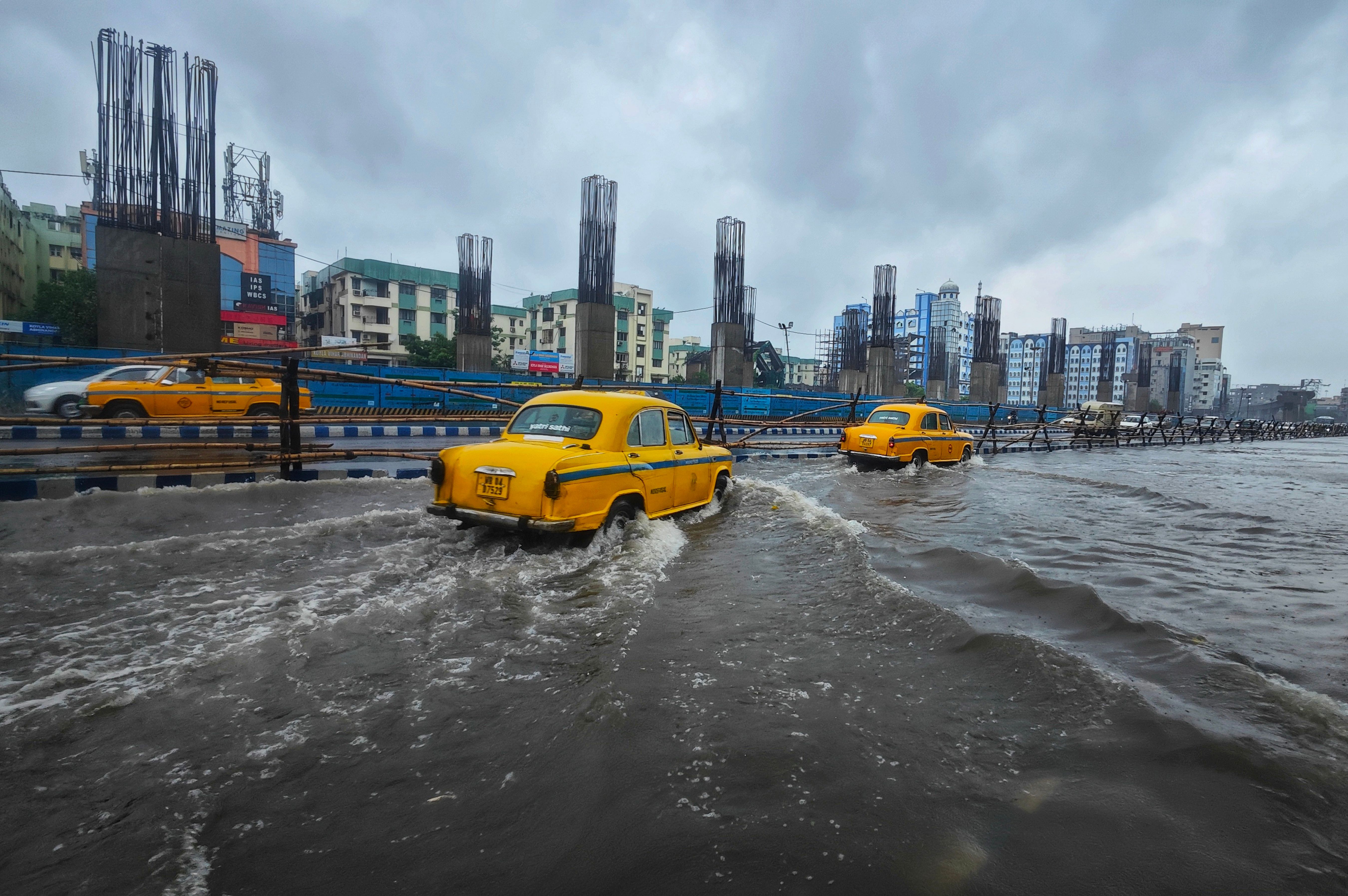 Cars Driving through a Flooded Street · Free Stock Photo