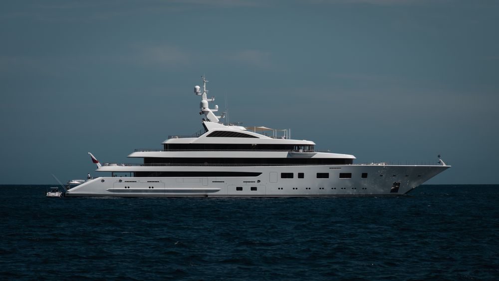 Sleek luxury superyacht cruising on open water