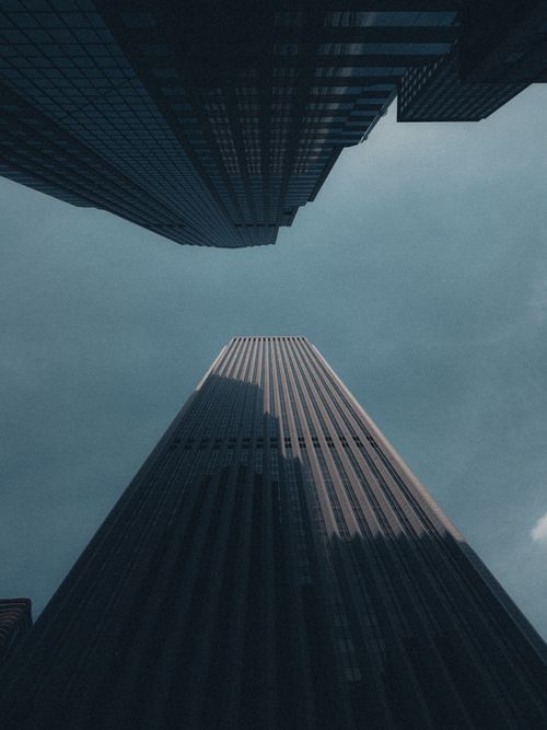 Free Low-angle shot of towering skyscrapers under a clear sky, showcasing urban architecture. Stock Photo