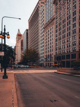 Empty city street in downtown Chicago showcasing historic buildings and urban architecture.