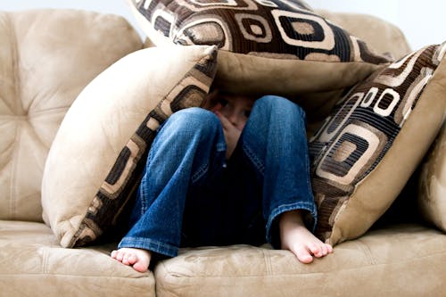 Free Kid hiding on Pillows Stock Photo