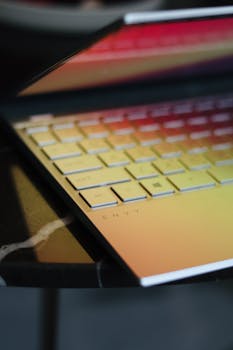 Close-up of a stylish laptop keyboard with a gradient sheen, in Dubai.