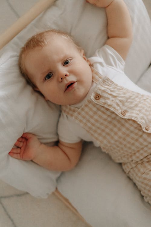 A Baby Lying on a Bed