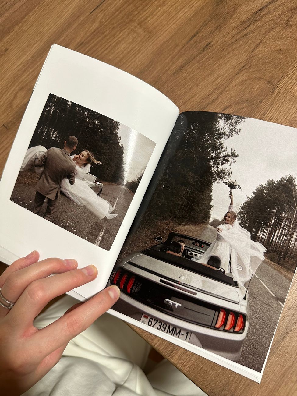 An open wedding album being browsed — the keepsake a QR-code shared album turns into
