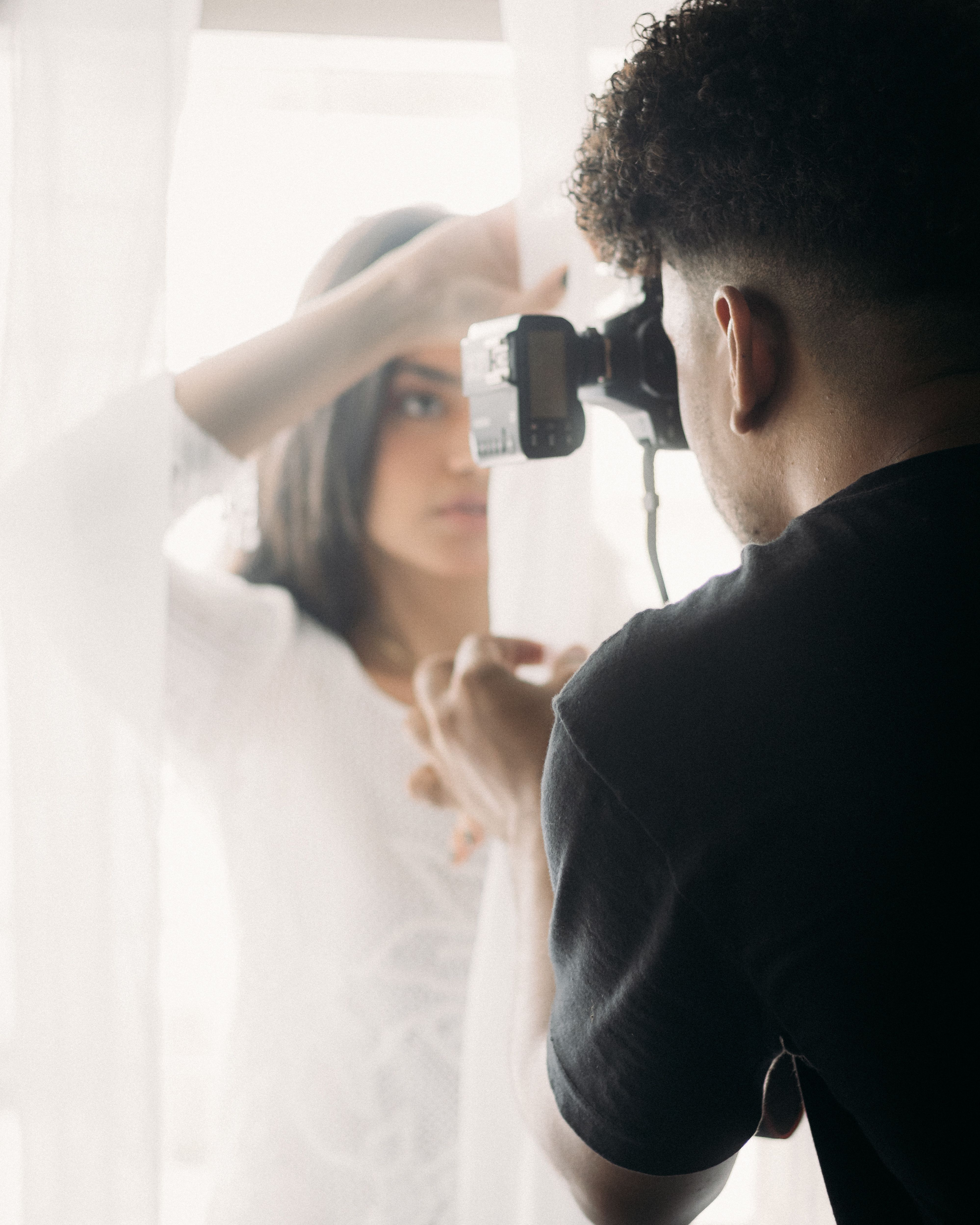 Man Taking Photo of Woman through Window · Free Stock Photo