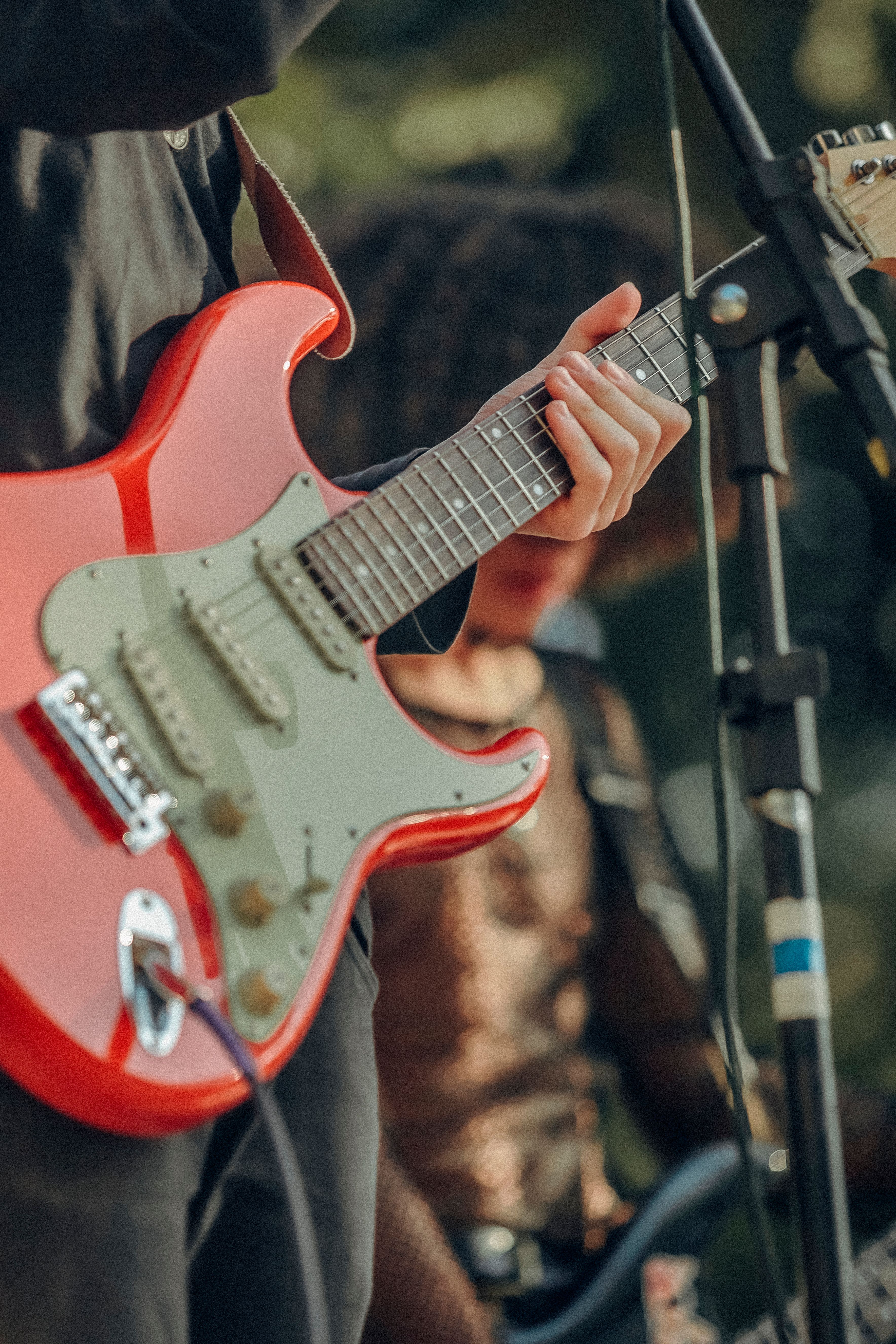 A musician skillfully plays an electric guitar at an outdoor concert.