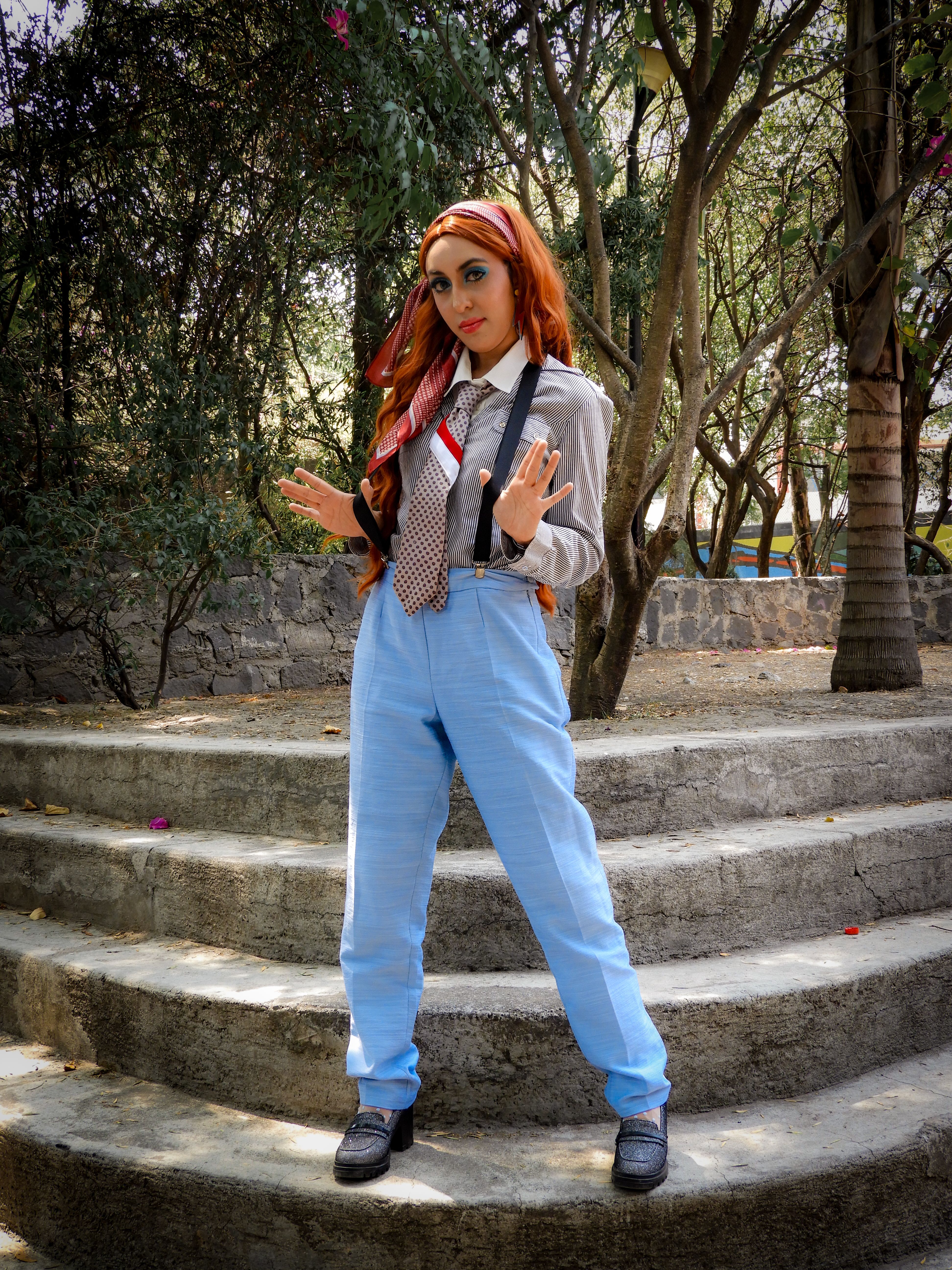 Red-haired woman in stylish suspenders outdoors