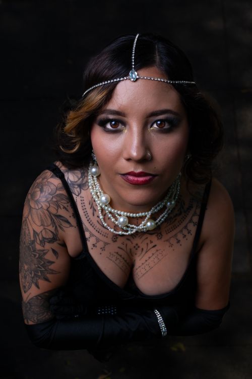 Free An artistic studio portrait focusing on jewelry and tattoos, capturing elegance and style. Stock Photo
