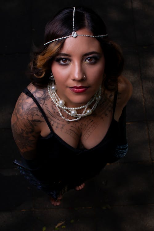 A woman with tattoos and jewelry on her head