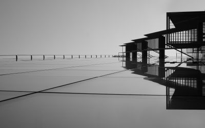 Geometric concrete and glass building against an open sky