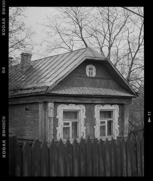 A black and white photo of a wooden house