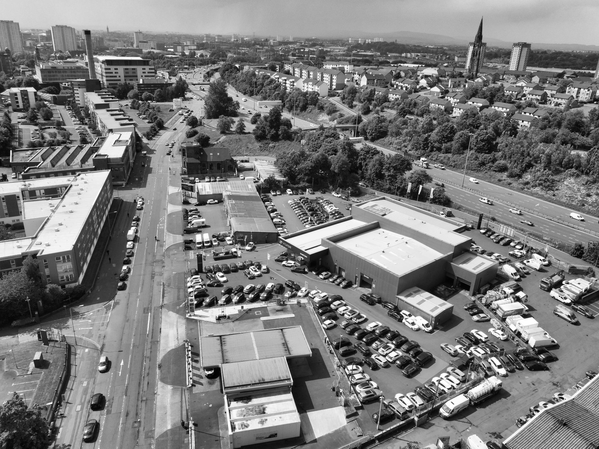 Cars on Parking Lot by the Factory in Black and White