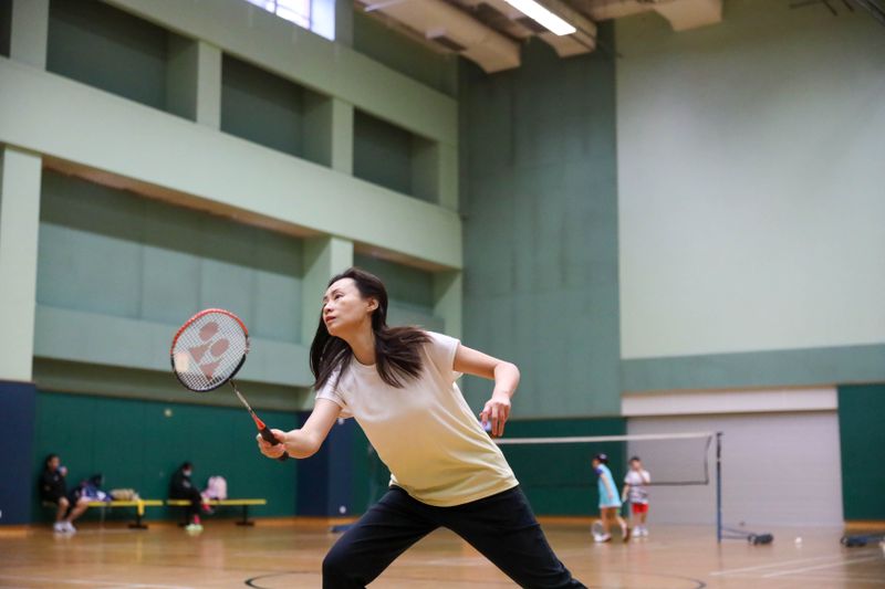 Player leaping for an overhead badminton shot