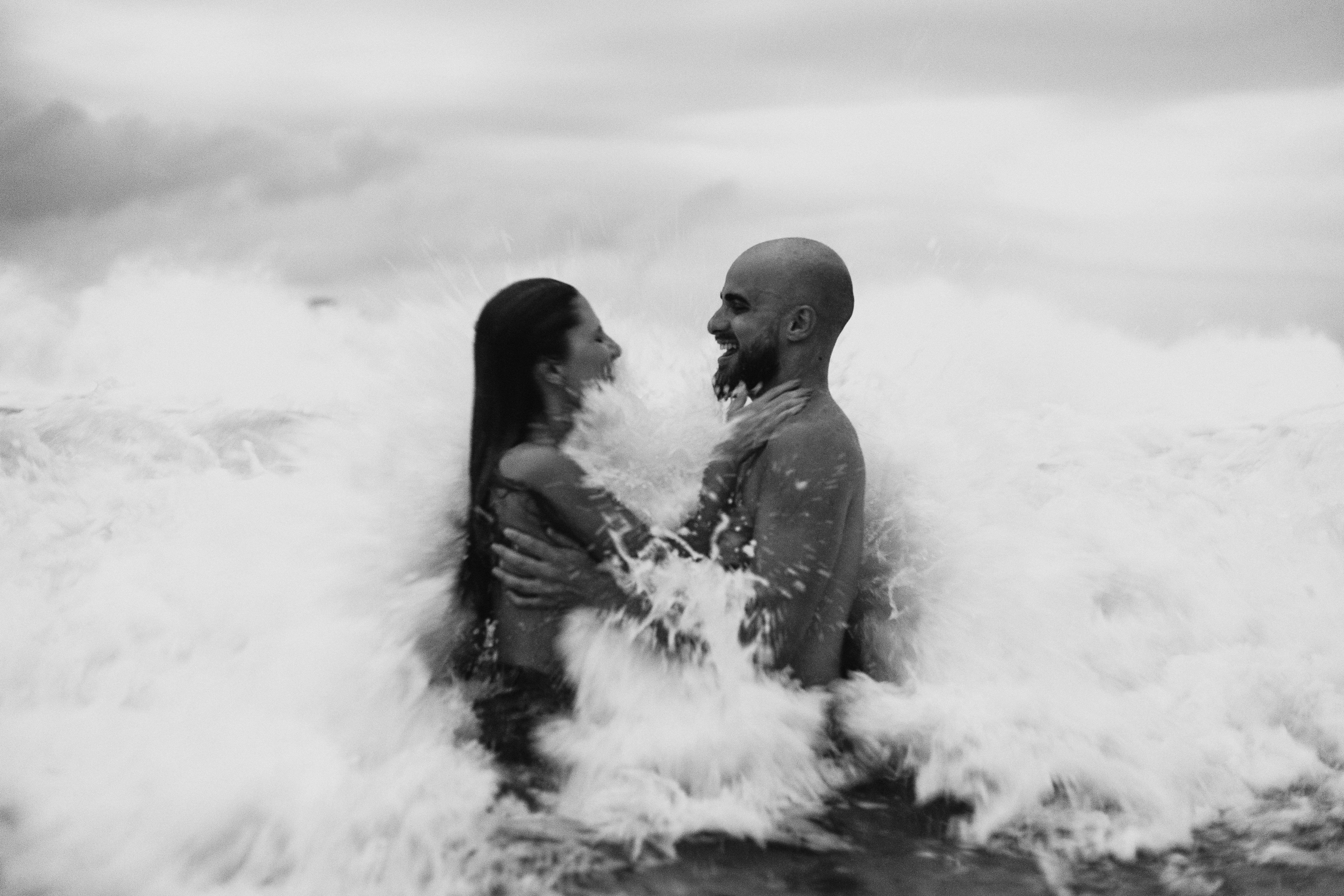 monochrome photo of couple in ocean