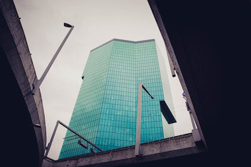 A tall building with a green glass front