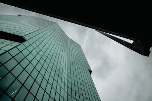 A view of a tall building with glass windows